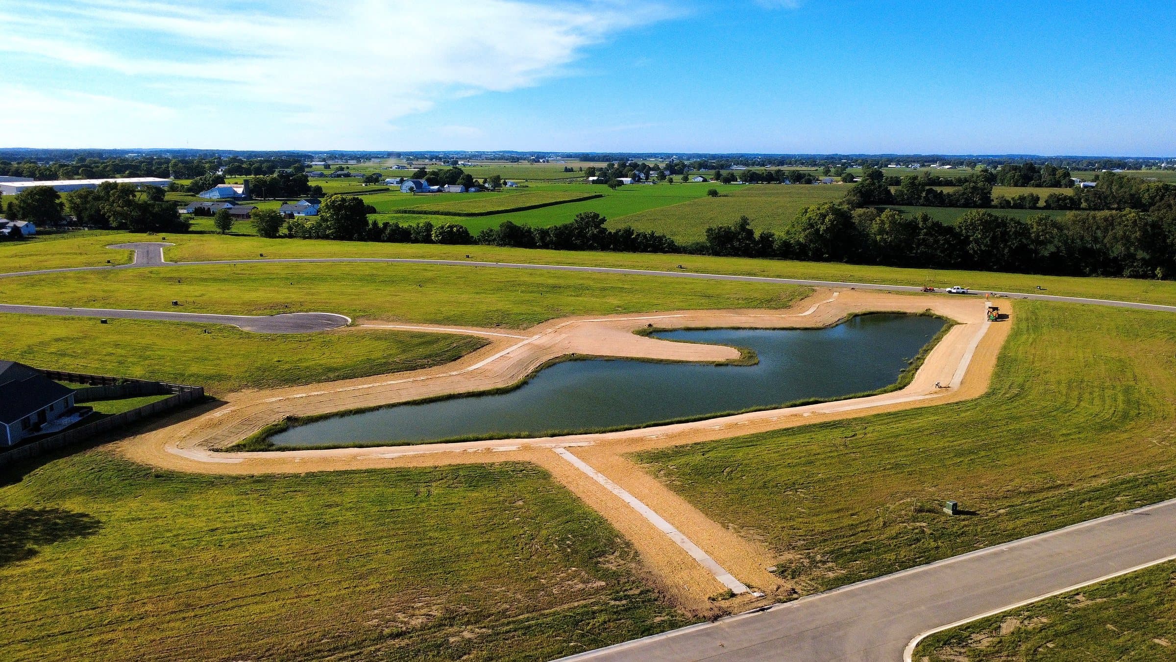Completed pond-bank seeding across a development site